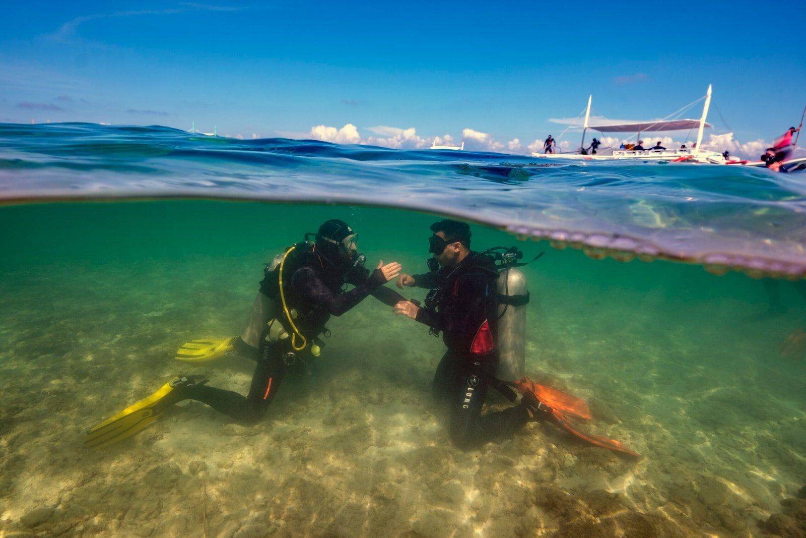 Instructor and student practising in the shallow water of Panagsama Beach