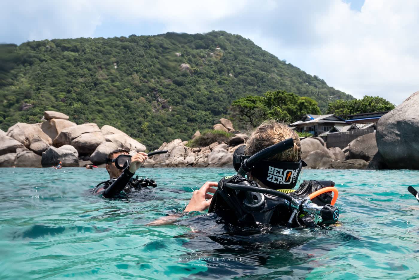 Two Below Zero divers walking into the water from the shore