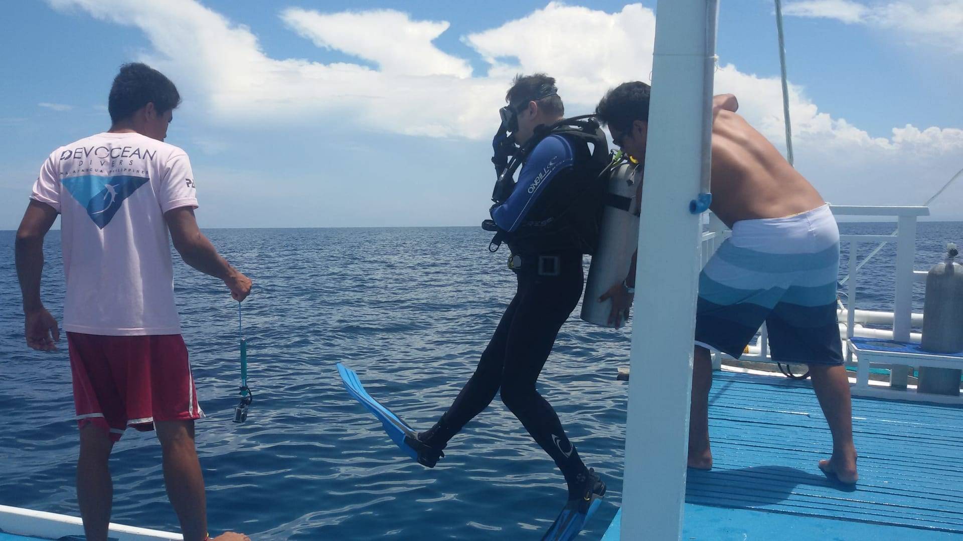A diver giant striding off the Devocean Divers boat