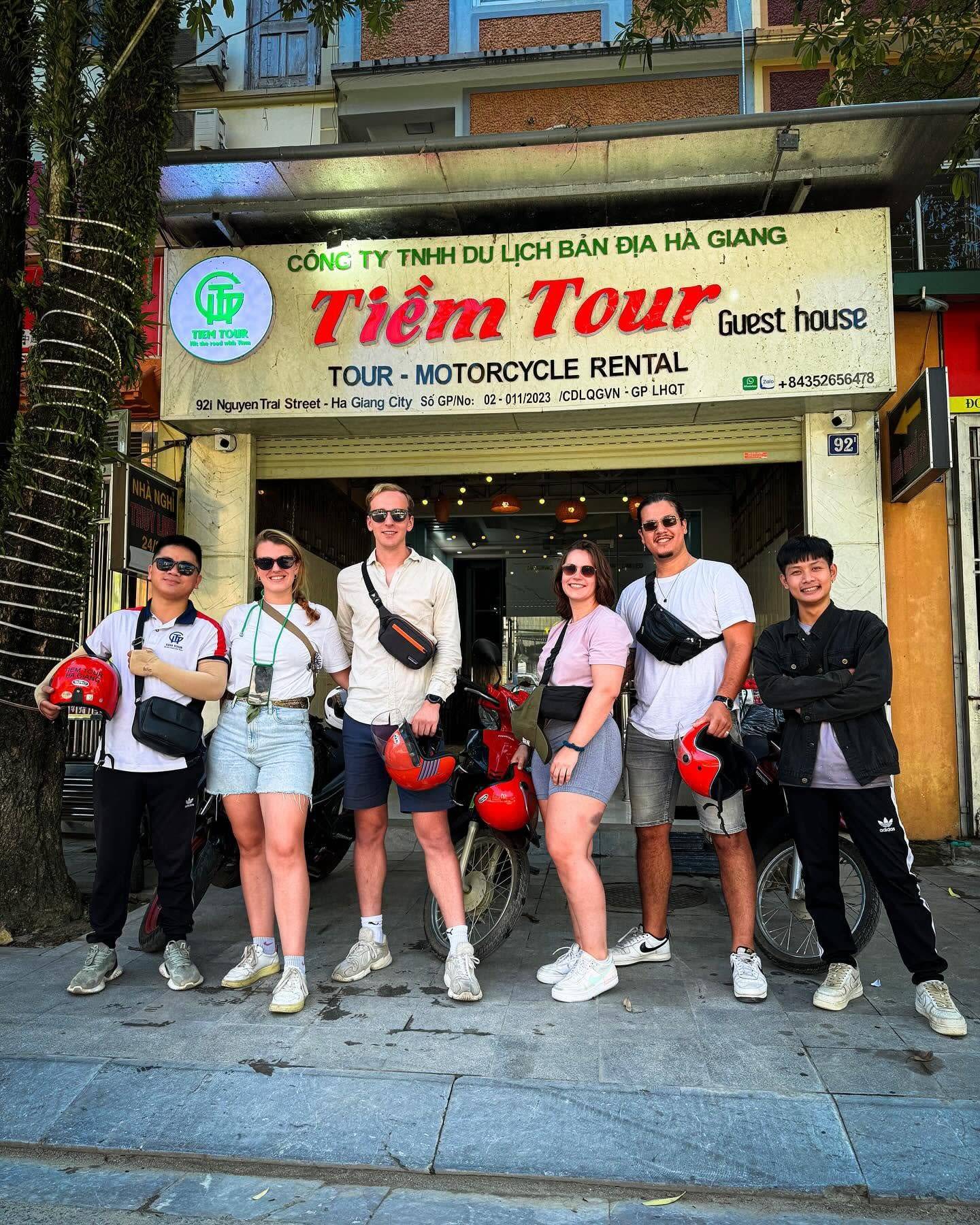 Travellers with their helmets outside the Tiem Tours office in Ha Giang