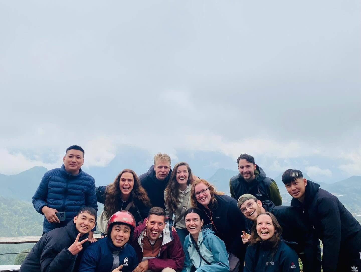 The whole group at a viewpoint above the mountains of Ha Giang