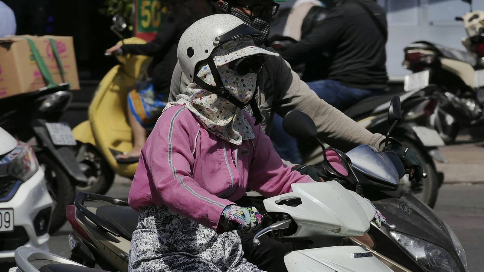 Rider in a white helmet in traffic