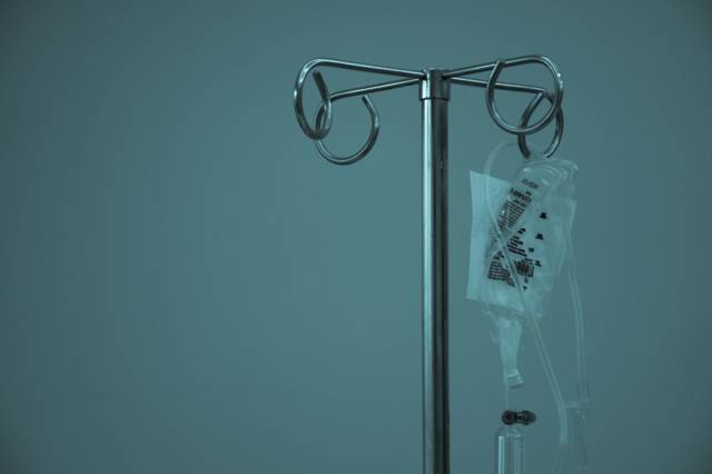 Drip bag on a stand in a hospital room