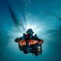Technical diver with a rebreather among the sardines off Moalboal