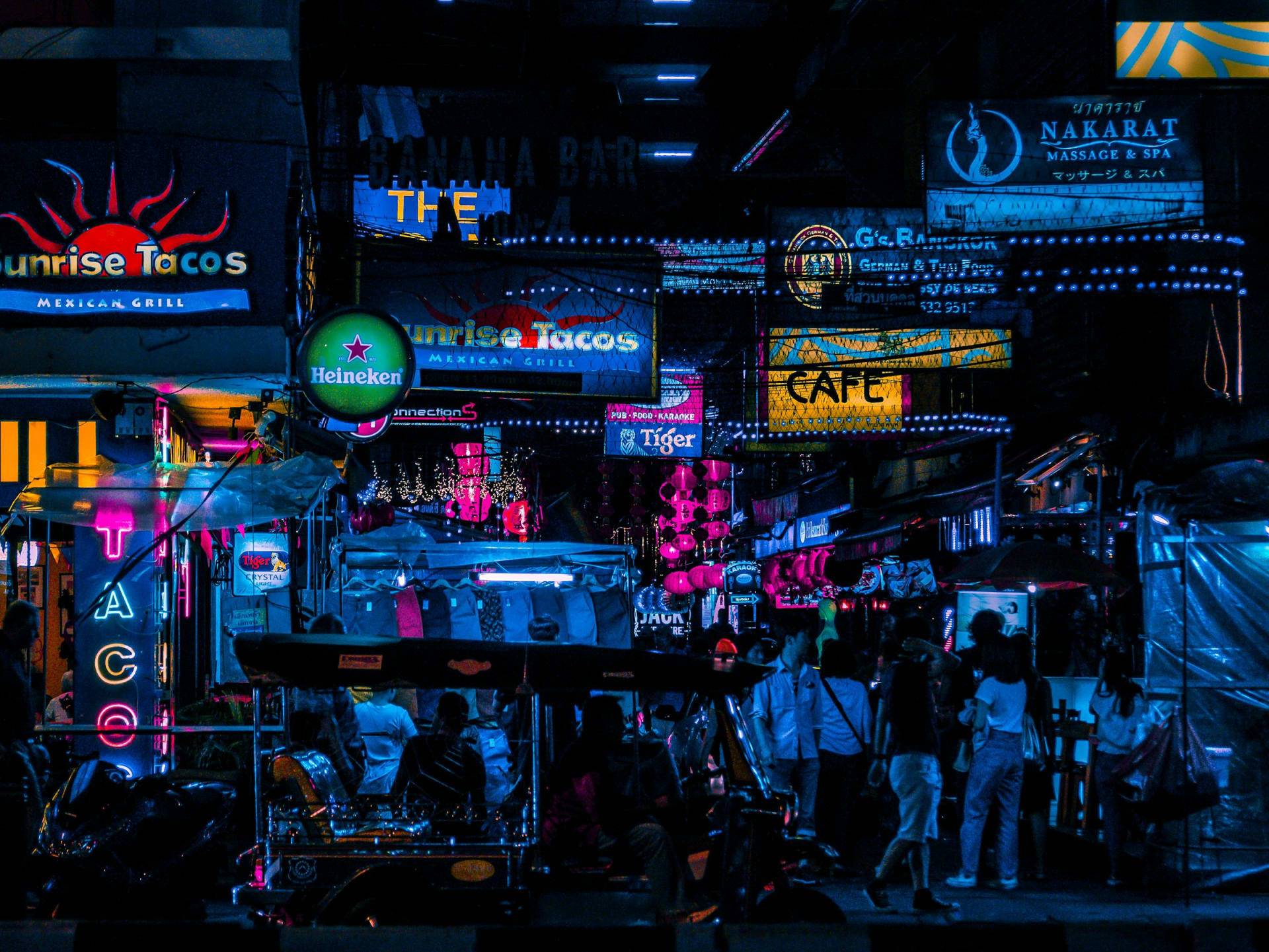 Night market stalls lit up along a city street