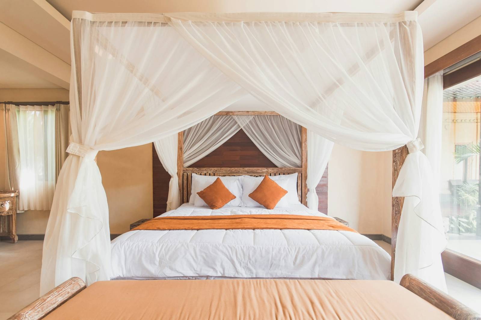 Bed under a white mosquito net