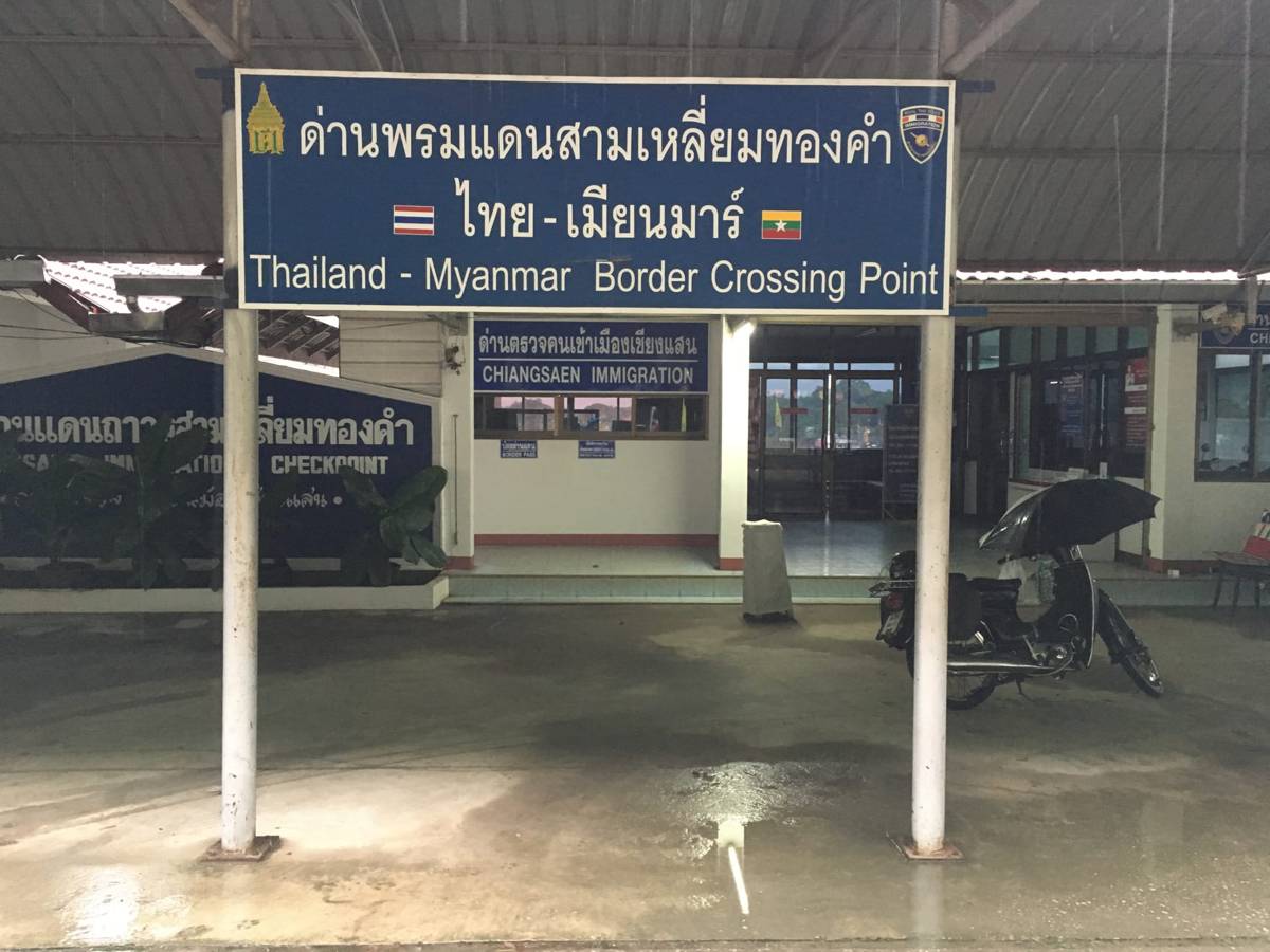 Sign at a border post reading Thailand Myanmar Border Crossing Point
