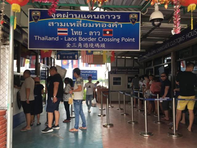 Travellers queueing at the border post between Thailand and Laos