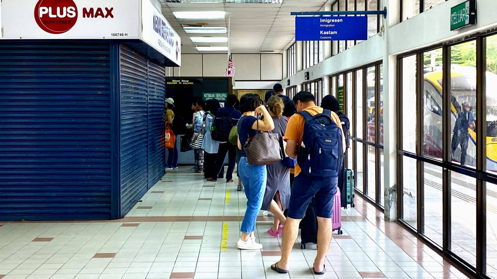 Queue at immigration and customs, with backpackers and suitcases