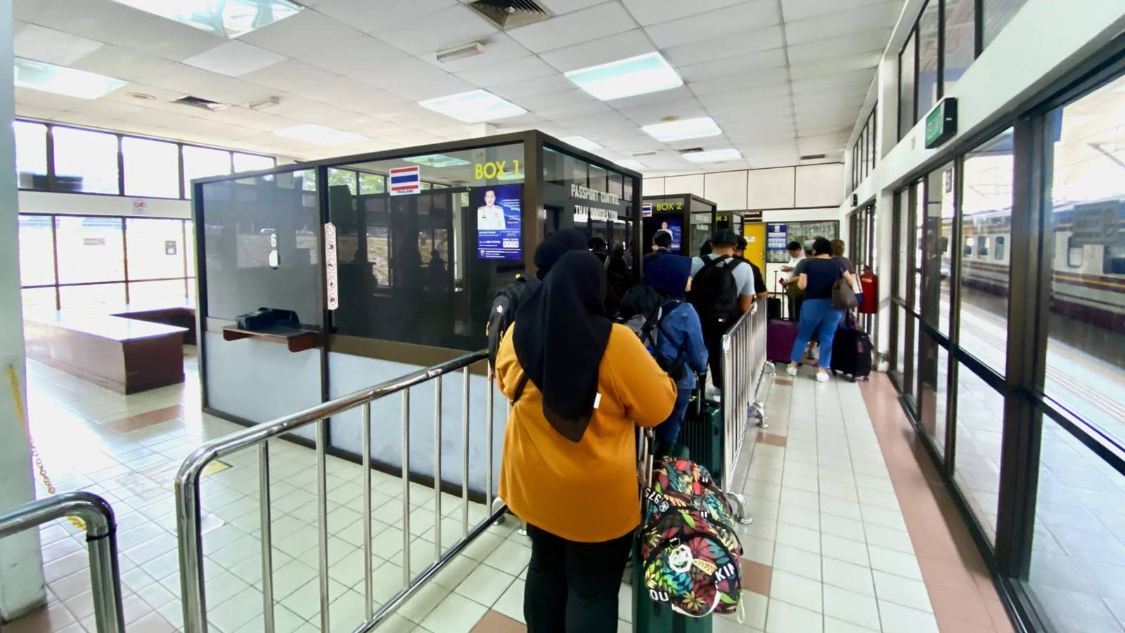 Travellers with backpacks queuing for passport control