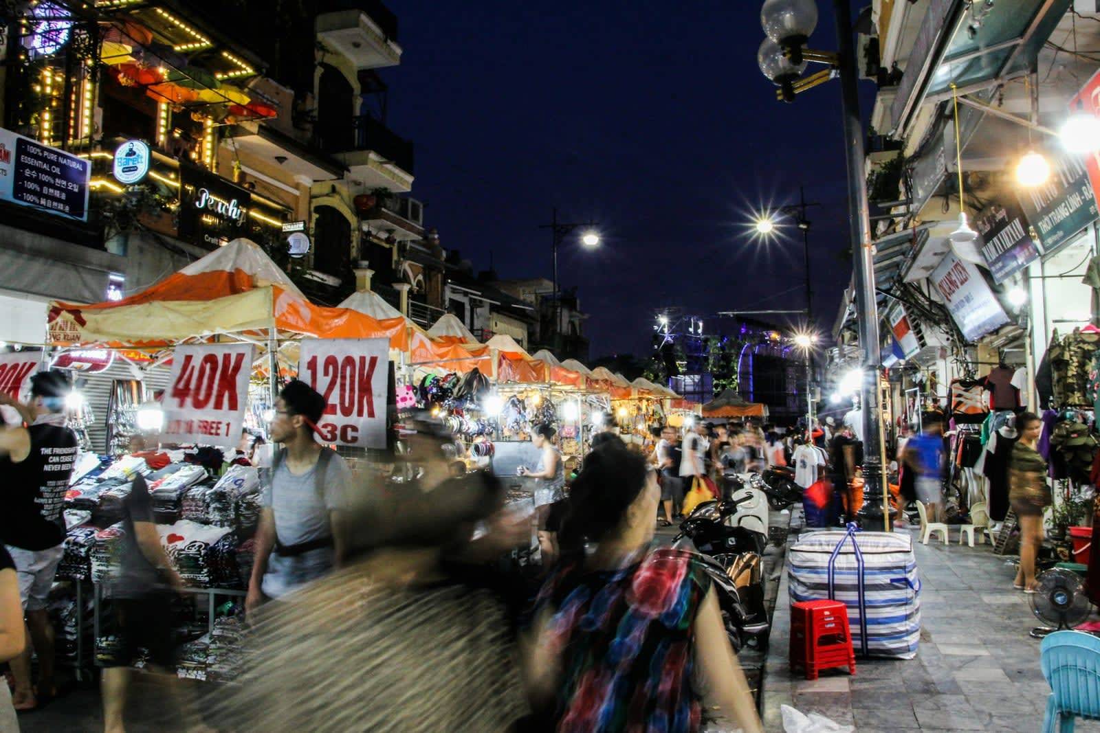 A busy night market with lit up stalls and shops