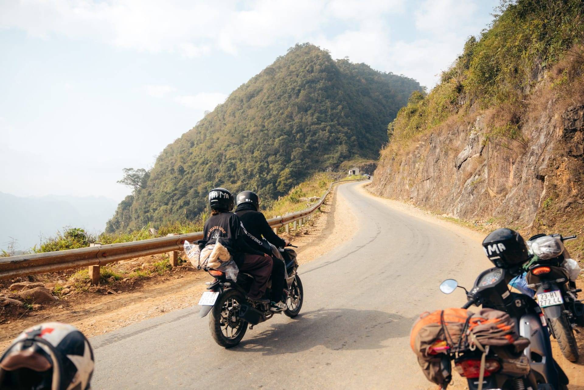 Two riders on a mountain road on the Ha Giang Loop