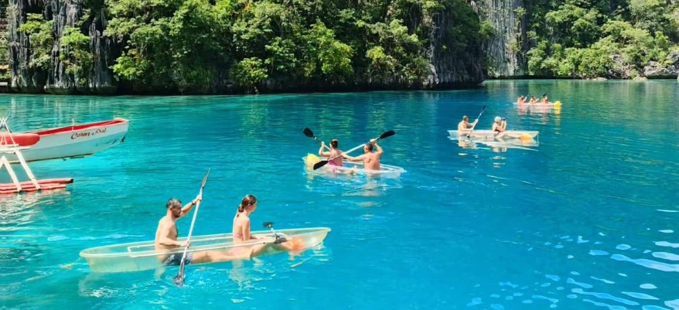 Kayaks in a turquoise lagoon between limestone cliffs