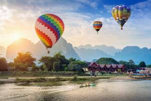 Hot air balloons over the river at Vang Vieng
