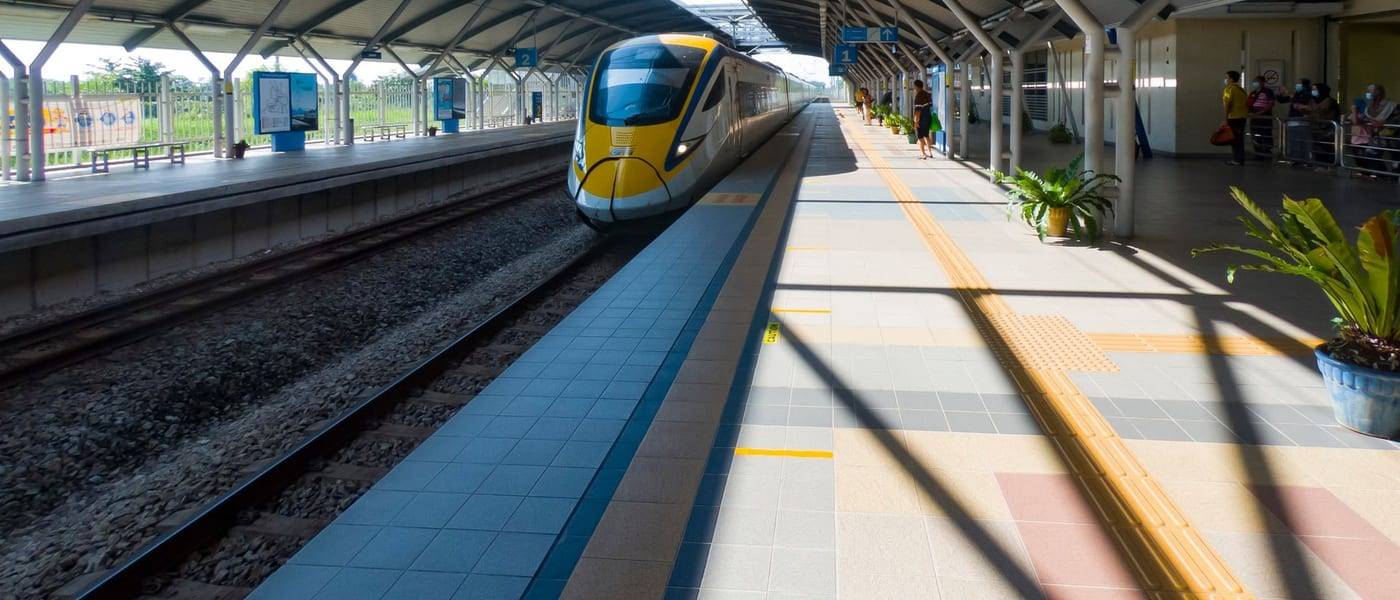 A yellow ETS train pulling into a modern station